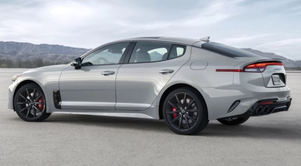 A grey 2021 Kia Stinger is shown from the side on a cloudy day.